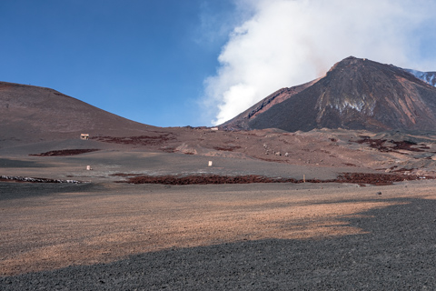 Mount Etna’s summit shows signs of collapse, with altered slopes and exposed volcanic material after the cone collapse in February 2022 under a clear sky.