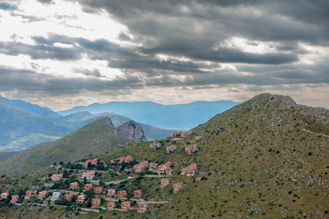 An unfinished villa sits on a hillside under a cloudy sky at Pizzo Sella, an abandoned development in Sicily, Italy.