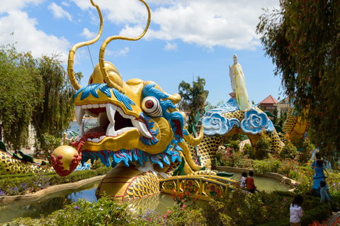A dragon sculpture winds through the gardens of Linh Phuoc Pagoda, a mosaic Buddhist temple on the outskirts of the city.